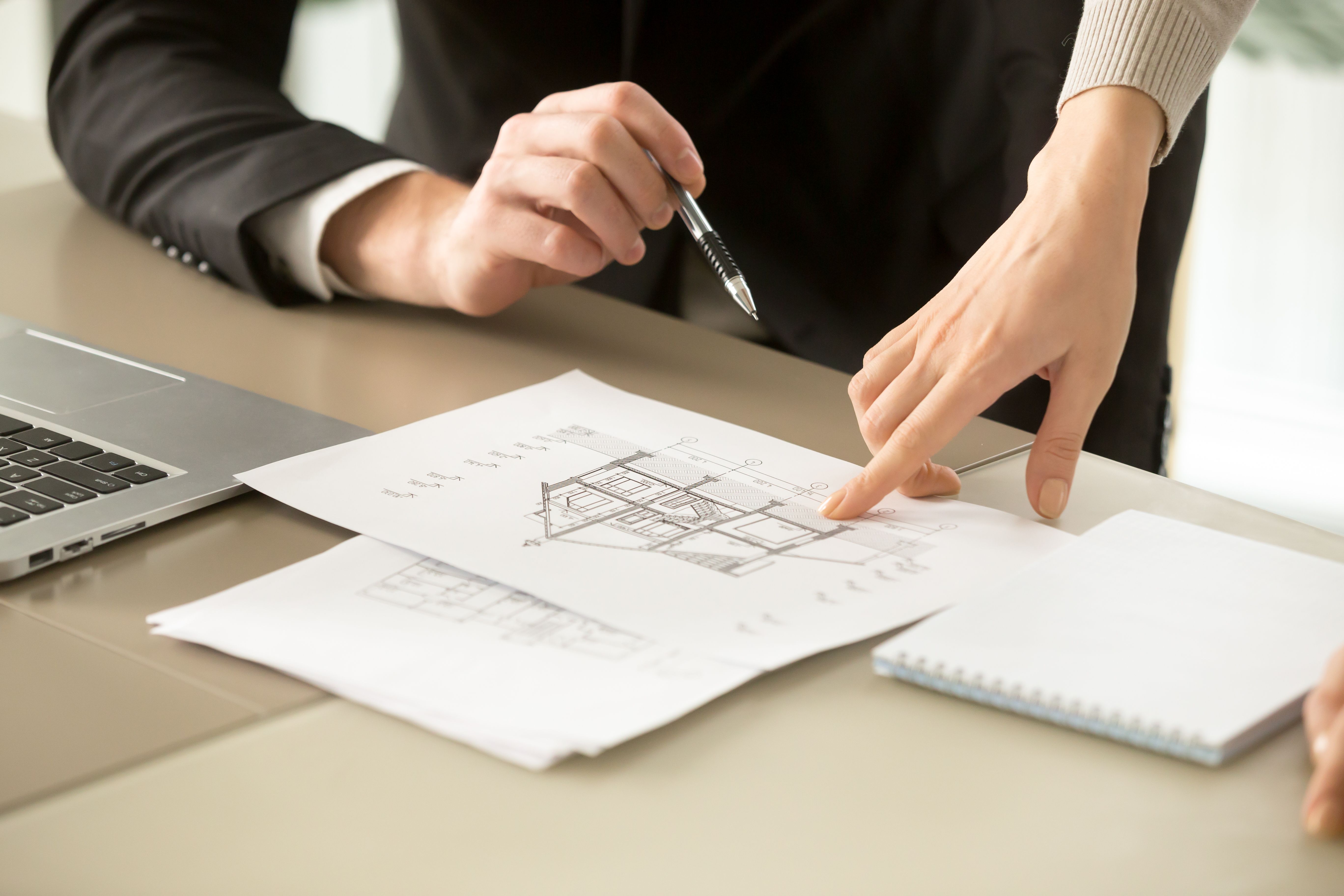 Real estate team reviewing building plans